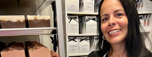 woman standing next to handmade soap